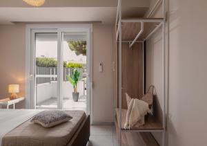 a bedroom with a bed and a balcony at Long Island House, Beachfront Hanioti in Hanioti +11 photos