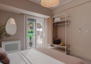 a bedroom with a bed and a glass door at Long Island House, Beachfront Hanioti in Hanioti