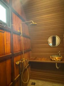 a bathroom with a shower with a sink and a mirror at Mây's Garden Villa in Tây Ninh +107 photos