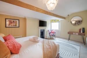 a bedroom with a white bed and a fireplace at Tellers secret loft apartment The Bank of England in Bristol +4 photos
