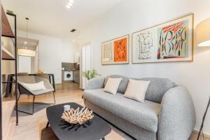 a living room with a couch and a table at Aspasios Rambla Catalunya Apartments in Barcelona