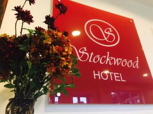 a vase of flowers in front of a store at Stockwood Hotel - Luton Airport in Luton