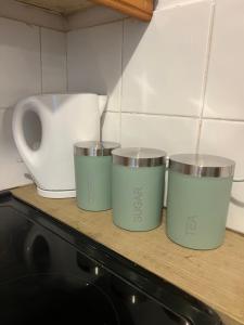 four measuring cups sitting on top of a counter at Cosy Cader Cottage in Dolgellau