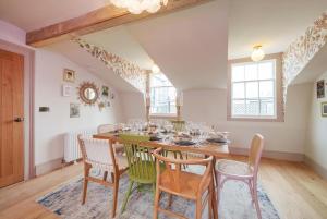 a dining room with a wooden table and chairs at Tellers secret loft apartment The Bank of England in Bristol