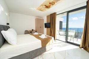 a bedroom with a bed and a balcony at Villa London in Novalja +33 photos
