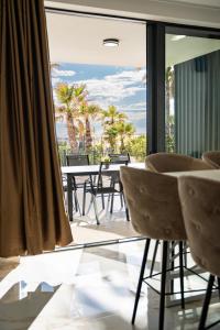 a room with a view of a table and chairs at Villa London in Novalja