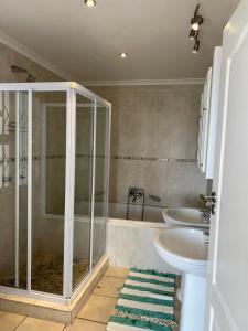 a bathroom with a shower and a toilet and a sink at Crayfish in Vredenburg +31 photos