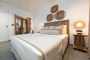a bedroom with a large bed and a closet at Villa Kelly Rooms & Suites in Naousa +47 photos
