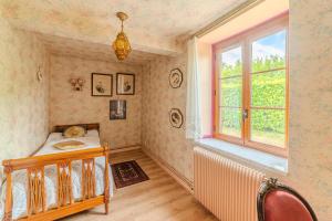 a bedroom with a bed and a window at Le Clos de Villecourt - Piscine Privée in Gueugnon +13 photos