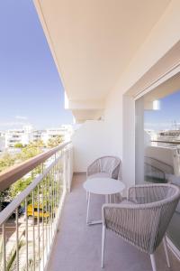 a balcony with a table and chairs and a view at Malacosta A - MC Apartments Ibiza in Ibiza Town