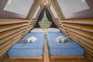 a room with two beds in a tent at Mobile Homes Camping Santa Marina, Lanterna in Poreč