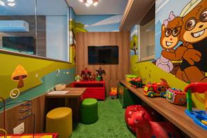 a childs play room with a mickey mouse mural at Hotel Laghetto Viale in Gramado