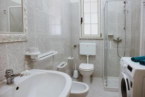 a bathroom with a sink and a toilet and a shower at Salentoandmore - Smeralda Onda Blu in Marina di Pescoluse +55 photos