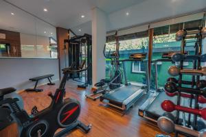 a gym with several exercise equipment in a room at Hotel Laghetto Viale in Gramado