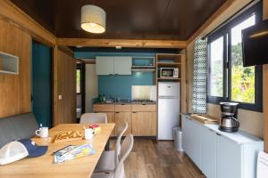 a kitchen with a wooden table in a room at CityKamp Angers in Angers