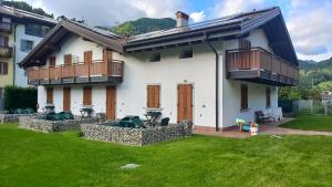a house with two balconies and a yard at Appartamenti Lilia - Ledro in Tiarno di Sopra