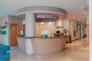 a lobby of a hospital with a reception counter at Hotel Laghetto Viale in Gramado