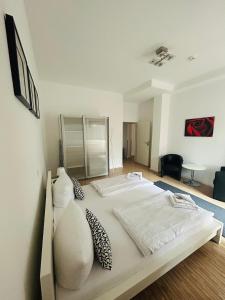 a large white bed with two pillows on it at Apartment & Boardinghouse Berlin Friedrichshain-Kreuzberg in Berlin