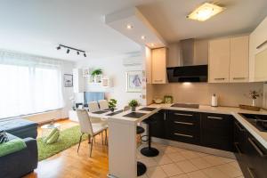 Una cocina y una sala de estar con mesa y sillas. en Flexible SelfCheckIns 79 - Zagreb - Garage - New, en Zagreb 24 fotos más