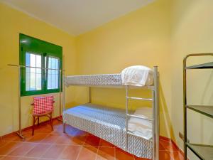 a room with two bunk beds and a chair at Holiday Home in Palamós near the Beach in Palamós