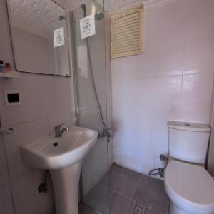 a bathroom with a sink and a toilet at Hbs Hotel in Kuşadası