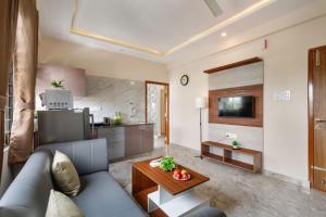 a living room with a couch and a table at OBS 1BHK with Balcony Koramangala in Bengaluru