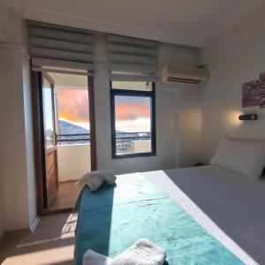 a bedroom with a bed and a large window at Hbs Hotel in Kuşadası
