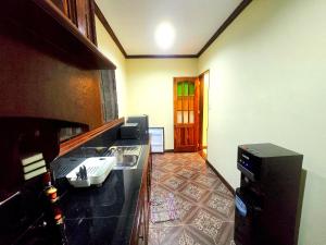 a room with a kitchen with a counter and a door at Villa Rosello in Dauis