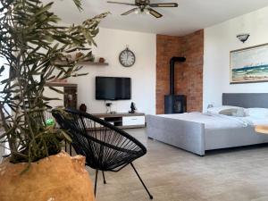 a bedroom with a bed and a clock on the wall at Apartments Maro in Senj