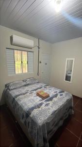 a bedroom with a bed with a tray on it at Pousada Rural João De Barro in Capela Ivapurunduva