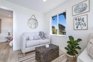 a living room with a couch and a table at Oceanfront Coastal Home with Breathtaking Views Hiking Beaches & More in Moss Beach
