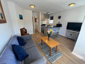 a living room with a couch and a table with flowers at 112 Clifden Glen in Clifden