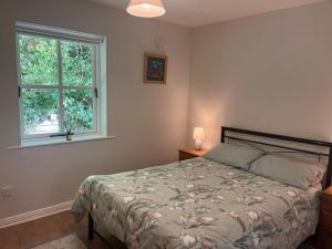 a bedroom with a bed and a window at 112 Clifden Glen in Clifden