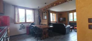 a kitchen with a table and chairs in a room at Le Chalet des Fées in Valmorel