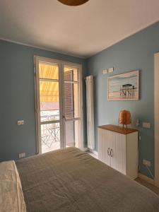 a bedroom with a bed and a large window at Casa Marina in Punta Marina