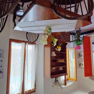 a room with windows and a surfboard on the ceiling at La Spezia Appartamento Fezzano in Fezzano