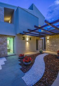 a house with a courtyard with flowers in it at Marthina Luxury Living in Nea Potidaea