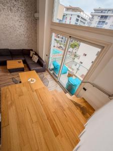 a living room with a couch and a table at Superior Duplex 3 in Shëngjin