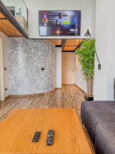 a living room with a tv and a table at Superior Duplex 3 in Shëngjin