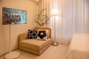 a living room with a chair and a tv at ANNA Stay in Seoul
