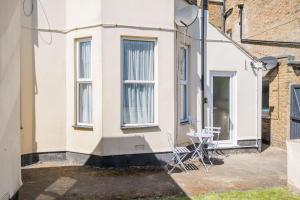 a house with two chairs and a table in front of it at Number 5 in Margate