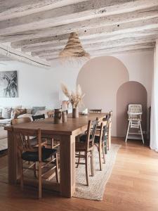a dining room with a wooden table and chairs at La Maison Gabriac in Boissise-la-Bertrand
