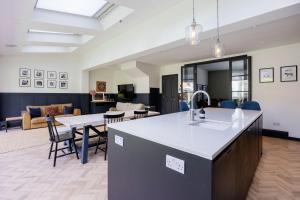 Una cocina y una sala de estar con mesa y sillas. en Veeve - The Garden Home, en Londres