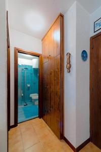 a bathroom with a walk in shower and a toilet at Appartamento Pineta in Chiesa in Valmalenco +19 photos