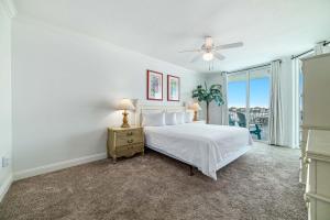 a bedroom with a bed and a ceiling fan at The Pass Unit 207 in Orange Beach