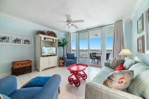 a living room with a couch and a tv at The Pass Unit 207 in Orange Beach