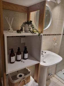 a bathroom with a sink and a toilet and a mirror at Ruka 7- Andarlibre in San Martín de los Andes +112 photos