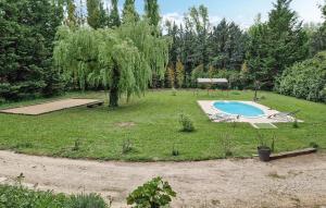 a yard with a swimming pool and a tree at Awesome Home In Goult in Goult