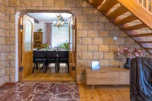 a dining room with a stone wall at Family House Rosa in Karpacz