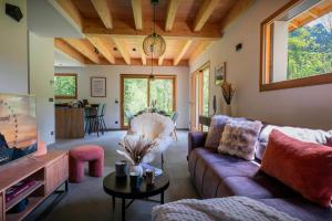 a living room with a couch and a table at Chalet Ormiages - OVO Network in Saint-Gervais-les-Bains